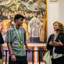 a group of people standing in front of a painting