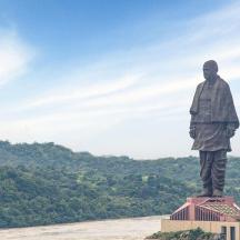 a statue of a man standing on top of a building