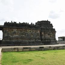 a large stone building in a field of grass