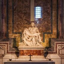 a statue of a woman sitting on top of a building