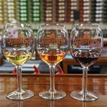 three wine glasses sitting on top of a table