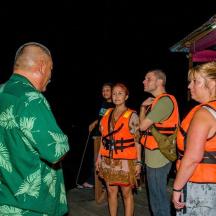 a group of people wearing orange vests standing together