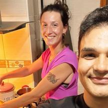 a woman standing next to a man in a kitchen