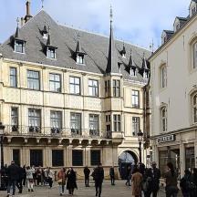 a group of people walking in front of a building