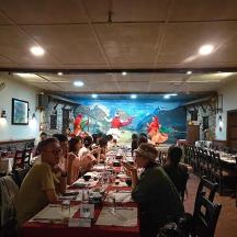 a group of people sitting at tables in a restaurant