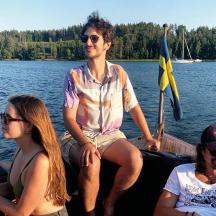 a group of people sitting on a boat on the water