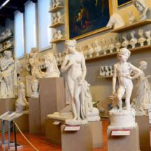 a room filled with statues on display in a museum
