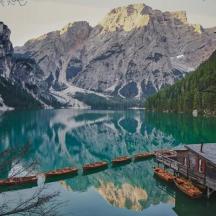 a house on a dock in the middle of a lake