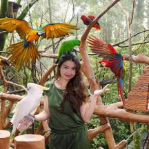 a woman standing in front of a group of birds