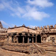 a large stone building with people sitting on it