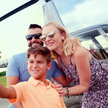 a group of people standing in front of a plane