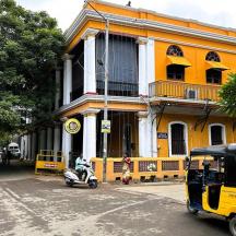 a yellow building with a scooter parked in front of it