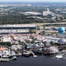 an aerial view of a city with a clock in the water