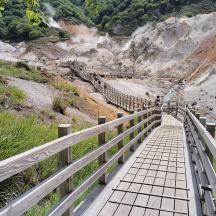 a bridge over a mountain with people walking on it