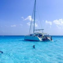 a boat in the ocean with people in the water