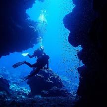 a person swimming in an underwater cave