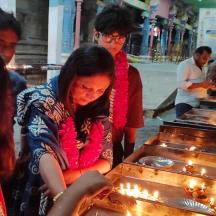 a group of people looking at lights in a temple