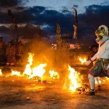 a man is standing in front of fire