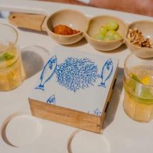 a table with drinks and bowls of food on it