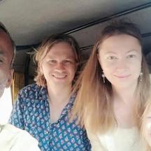a group of three people sitting in a car