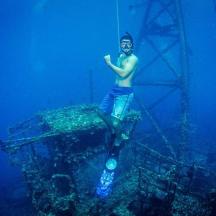 a man standing on top of a tower in the water