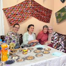 a group of people sitting around a table with food