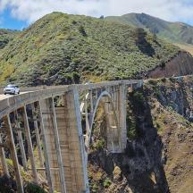 a bridge on a mountain with cars on it