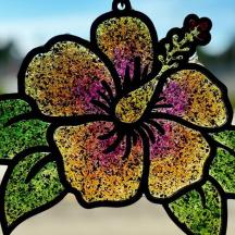 a stained glass window with a flower