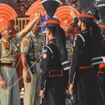 a group of people in uniform with umbrellas