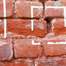 a brick wall with white writing on it