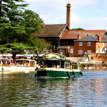 two boats floating on the water in a river