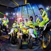 a group of people on motorcycles in a gym