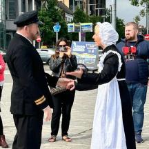 a man and a woman shaking hands on a street