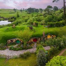 an aerial view of a house on a hill with a pond