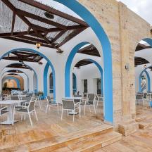 a restaurant with blue arches and tables and chairs