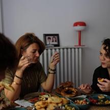 a group of people sitting at a table eating food