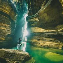a person standing in front of a waterfall