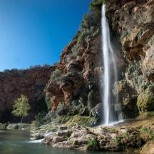 a waterfall on the side of a mountain