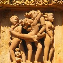 a stone wall with a bunch of statues on it