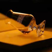 a glass bottle sitting on top of a table