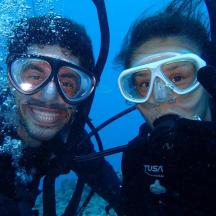 two people are posing for a picture in the water