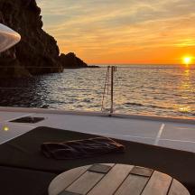 a boat with a wooden paddle on the front of a sunset