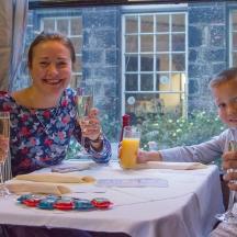 a group of people sitting at a table with a child