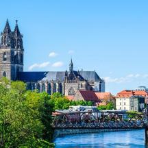 a bridge over a river in front of a city