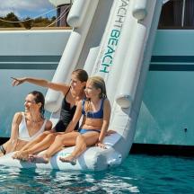 four women sitting on an inflatable raft on a boat