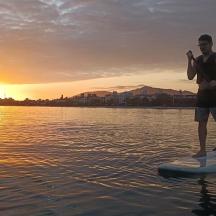 a man standing on a paddle board in the water
