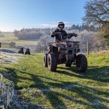 a man riding a quad bike in a field