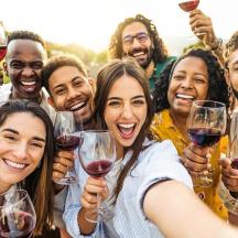 a group of people holding glasses of wine