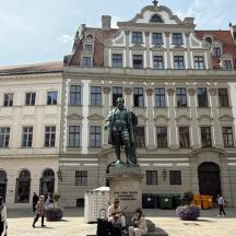 a large building with a statue in front of it