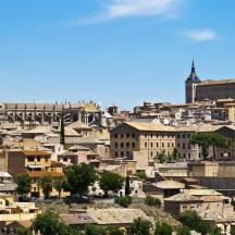 a cityscape of a city with buildings and a cathedral